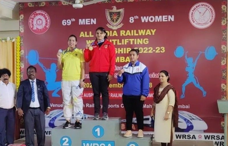 Usha Kumara on podium after winning gold in Railways Weightlifting Championship in 2022