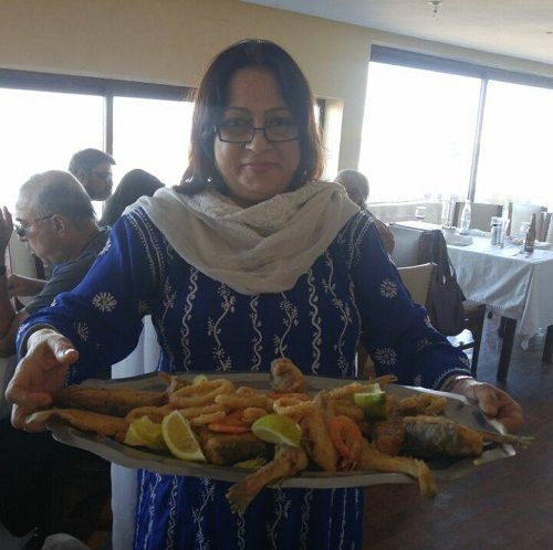 Vrushali Gokhale holding a plate full of seafood