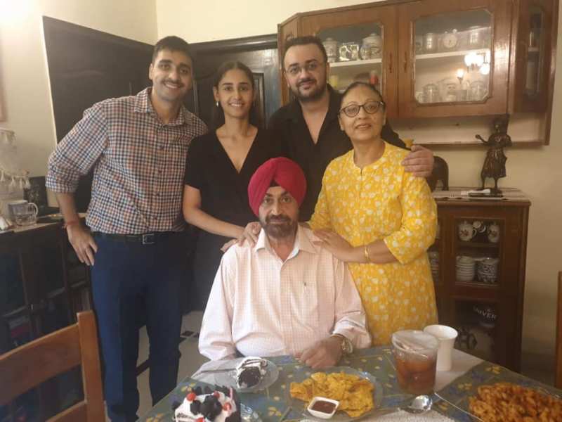 A photo of Hasleen Kaur with her husband, mother, father, and brother