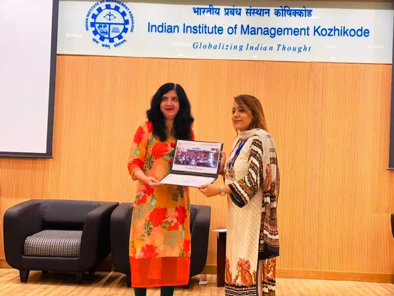 A photo of Shelly receiving her certification at IIM-Kozhikode
