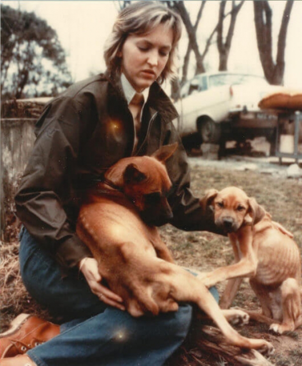 A picture of young Ingrid Newkirk patting dogs