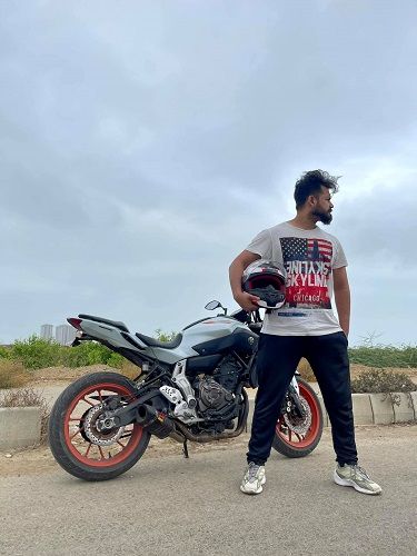 Azlan Shah posing with his Yamaha motorcycle