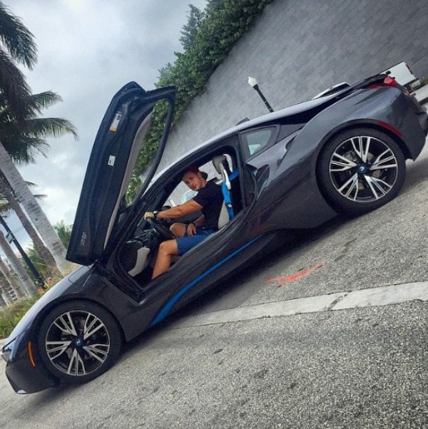 Dr Mike sitting in his BMW i8