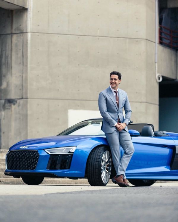 Dr Mike standing next to his Audi R8 Spyder