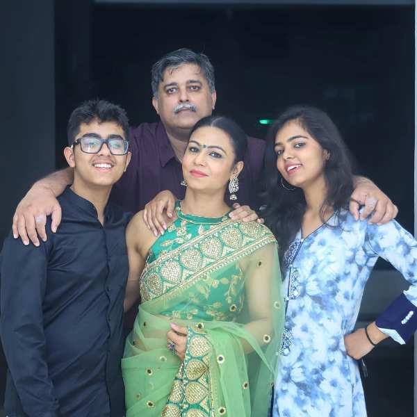 Kiran Dembla (center, in green) with her husband Ajit, son Kshitij (left), and daughter Priyanka (right)