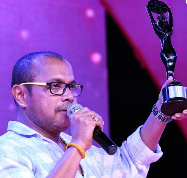 Naveen D. Padil posing with his Versatile Actor Award at the Red FM Tulu Film Awards