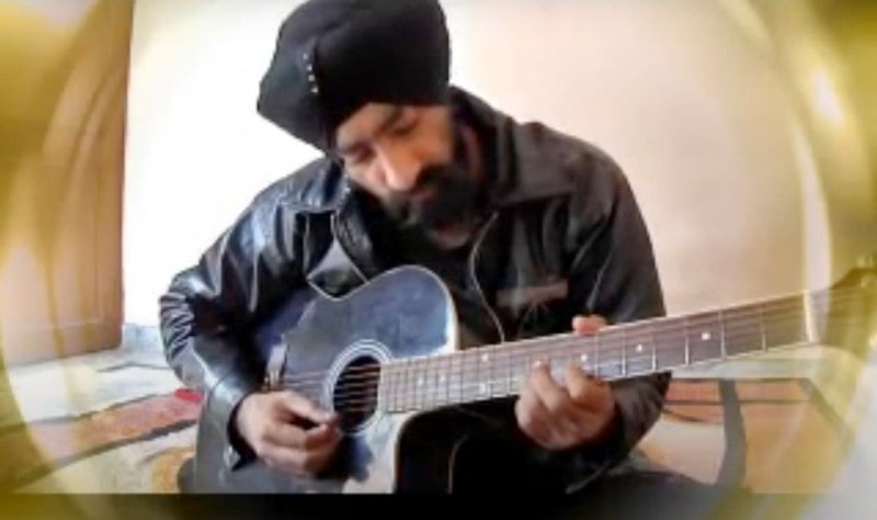 Paramjeet Singh playing the guitar