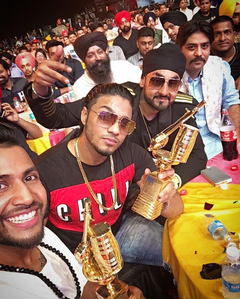 Raftaar posing with Best Music Director and Best Club Song Of The Year at PTC Punjabi Music Awards