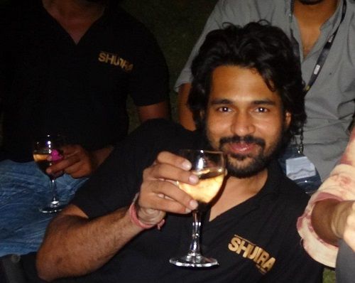 Shreedhar Dubey holding a glass of alcohol