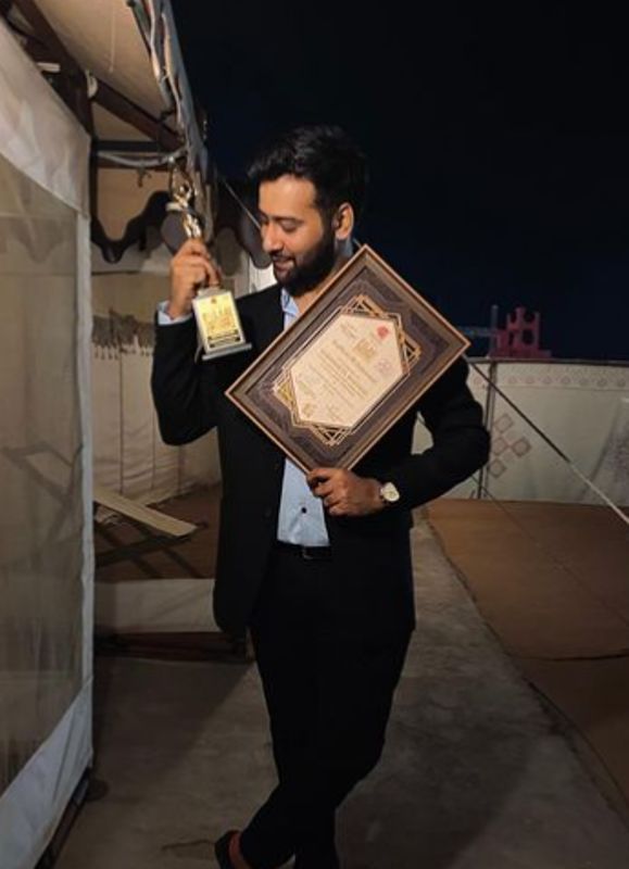 Siddharth Amit Bhavsar posing with his award for Best Singer Male - Critics Choice at the Film Excellence Awards Gujarati