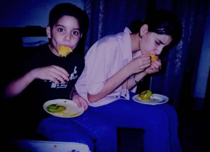 A childhood picture of Anahita Dhondy and her brother while eating mangoes