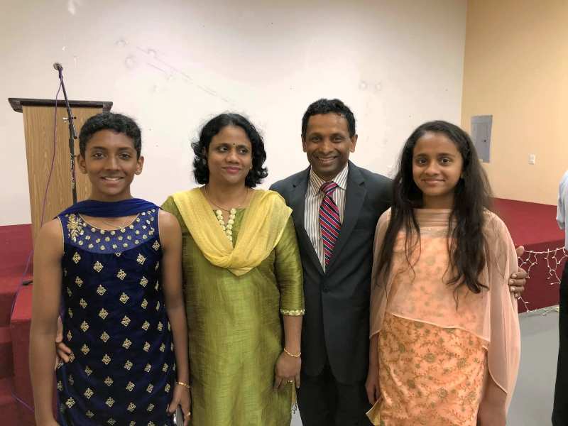 A photo of Surendran K. Pattel with his wife and daughters