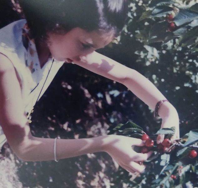 A picture of Anahita Dhondy picking cherries in Cyprus in 1999
