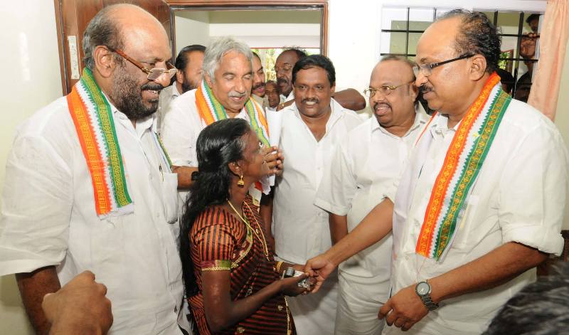 A. K. Antony handing over house built under the Ambilikku Oru Veedu project to actress Molly Kannamaly in Chellanam in 2013