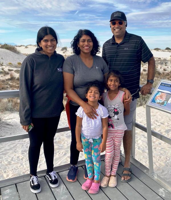 An image of Juli A Mathew with her husband and daughters