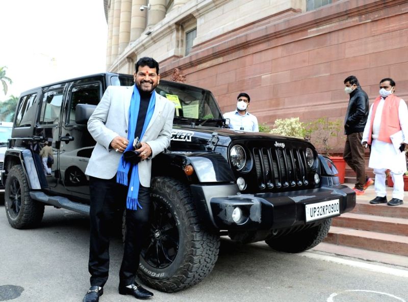 Brij Bhushan Sharan Singh posing with his Jeep Wrangler car outside Parliament House, Delhi