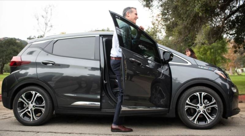 Eric Garcetti getting out of his Chevrolet Bolt car