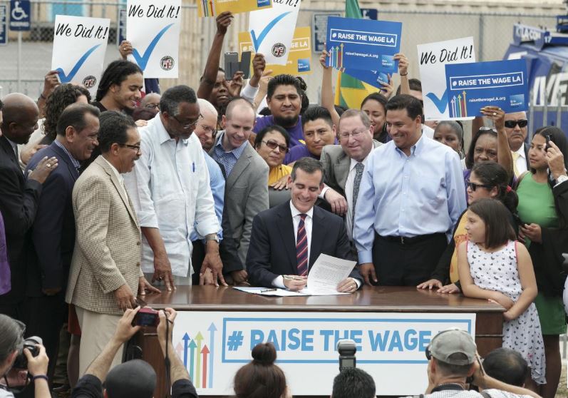 Eric Garcetti signing $15 hour minimum wage hike into law in 2015