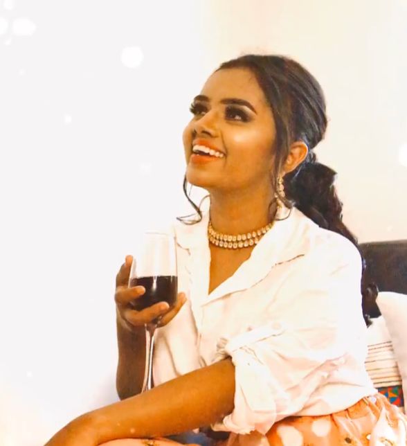 Jhanvi holding a glass of wine-