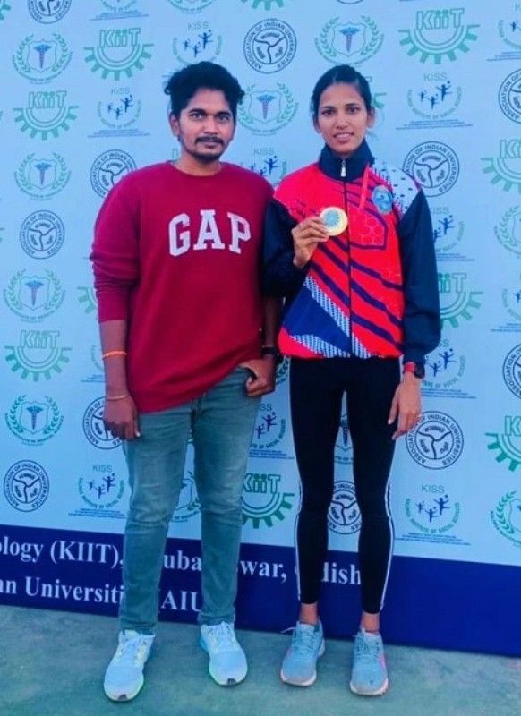 Jyothi Yarraji (right) with her University coach, Praveen Kumar