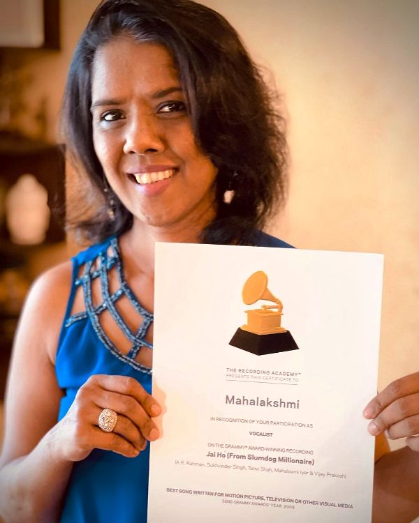 Mahalakshmi Iyer holding her The Recording Academy certificate