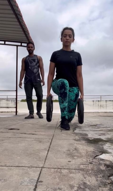 Saanve Megghana, along with her fitness trainer, while working out on a terrace