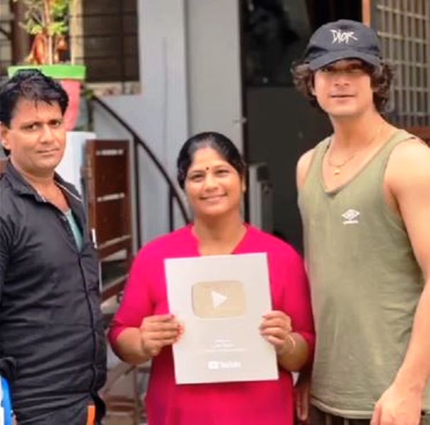 Tarun Namdev with his parents posing with his YouTube Silver Play Button