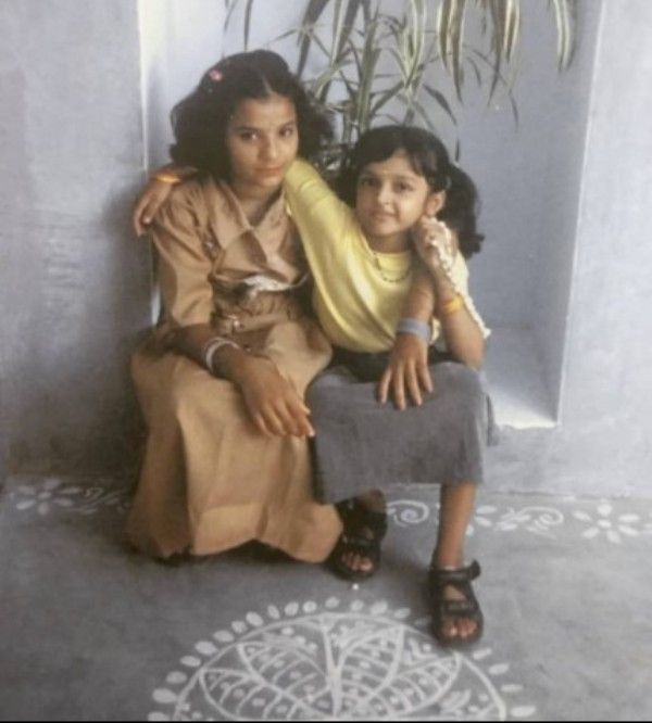 A childhood image of Annmary Tom (right)