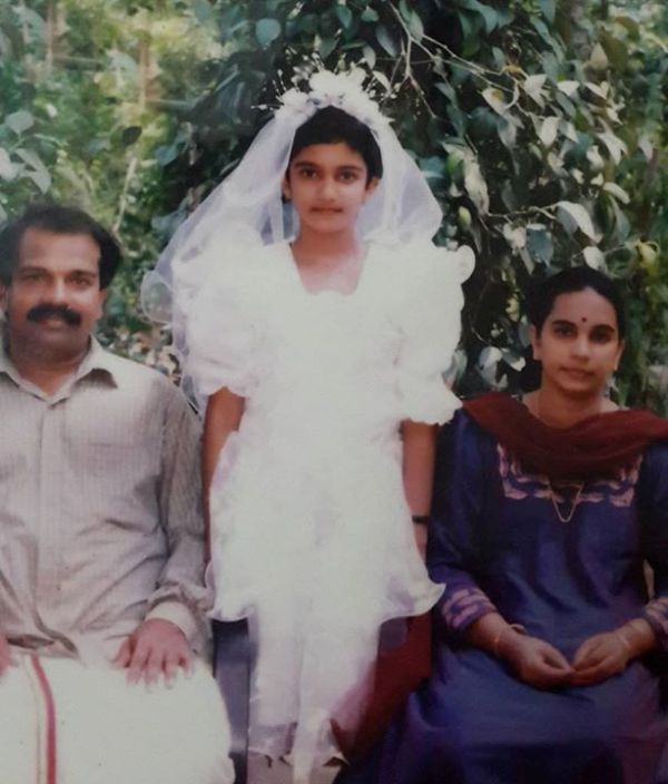A childhood photo of Honey Rose with her parents