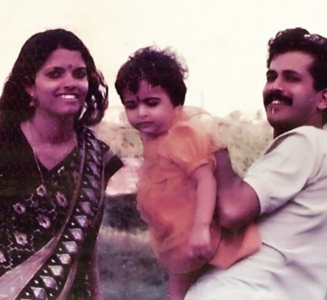 A childhood picture of Parvathy Omanakuttan with her parents