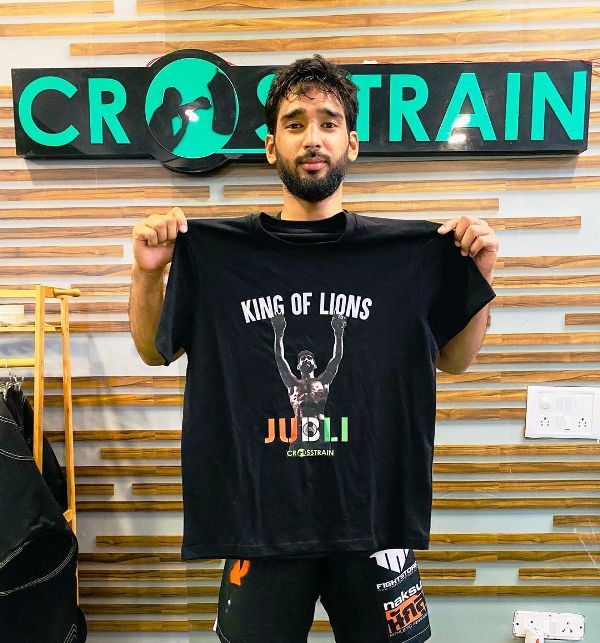 A photo of Anshul Jubli taken while he was posing with a T-shirt gifted to him by CFC