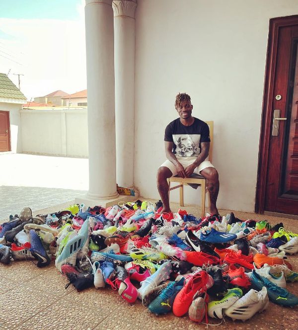 Christian Atsu with the 80 pairs of football shoes he donated to the young players of Cheetah F.C.