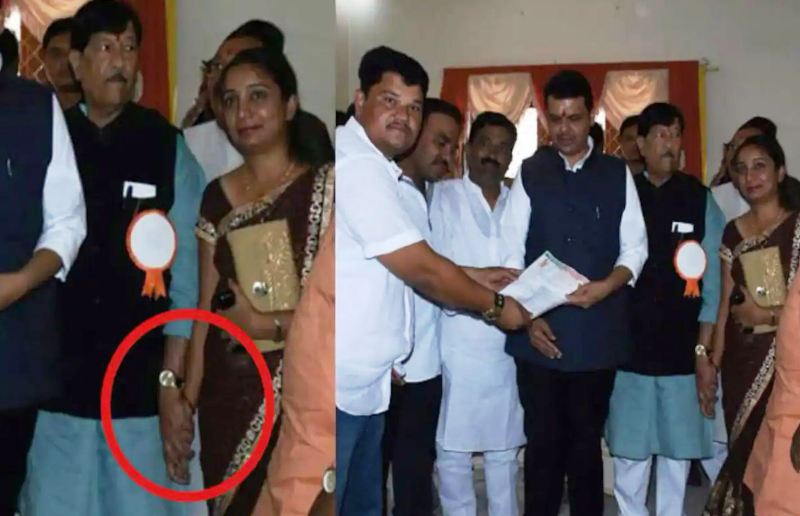 A viral image of Girish Bapat holding hands of a woman party worker