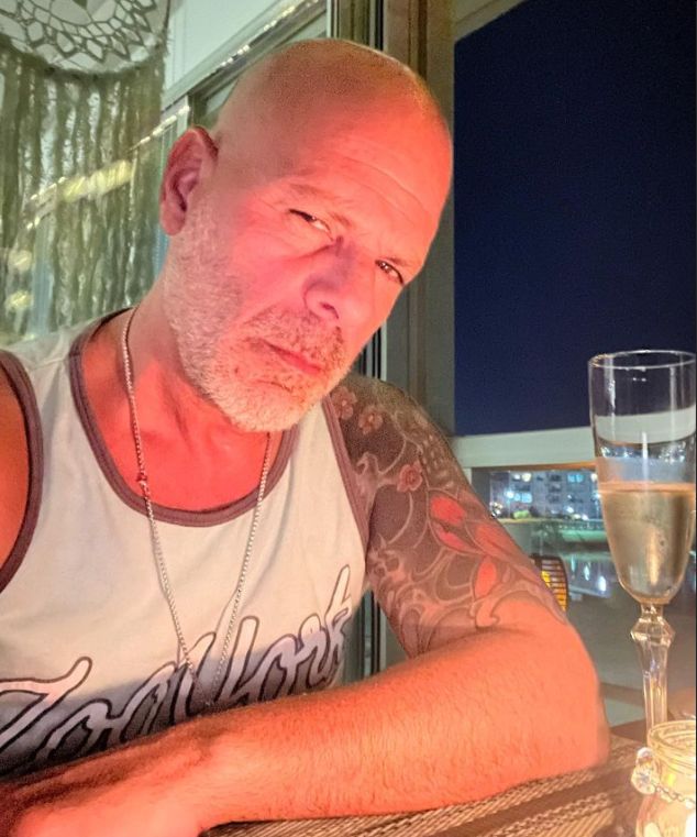 Bruce Willis having an alcoholic beverage