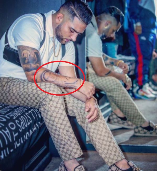 Karan Aujla's mother's face tattoo on his right forearm