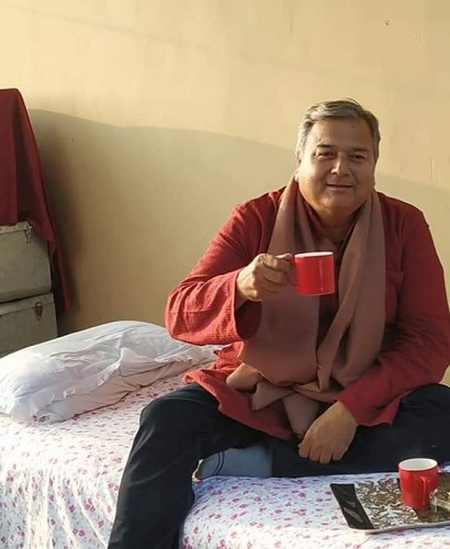 Peepal Baba holding a cup of tea