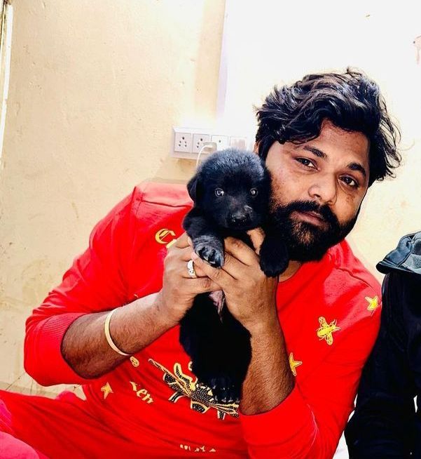 Samar Singh with a puppy