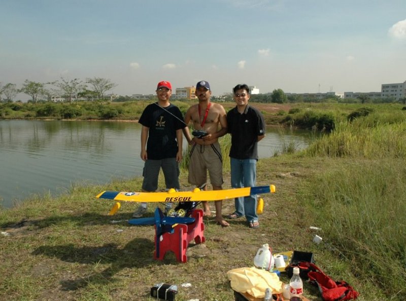 Zaharie Ahmad Shah (centre) while experimenting with a remote-controlled aircraft model near a lake along with his friends in July 2012