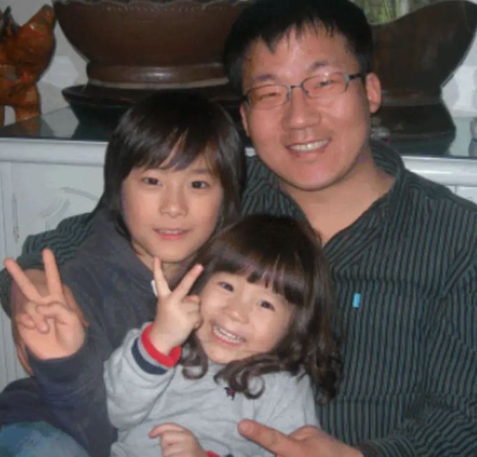 A childhood image of Moon Bin with his sister and father