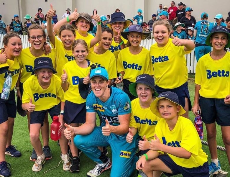 A photograph of Grace Harris with the Brisbane Heat fans