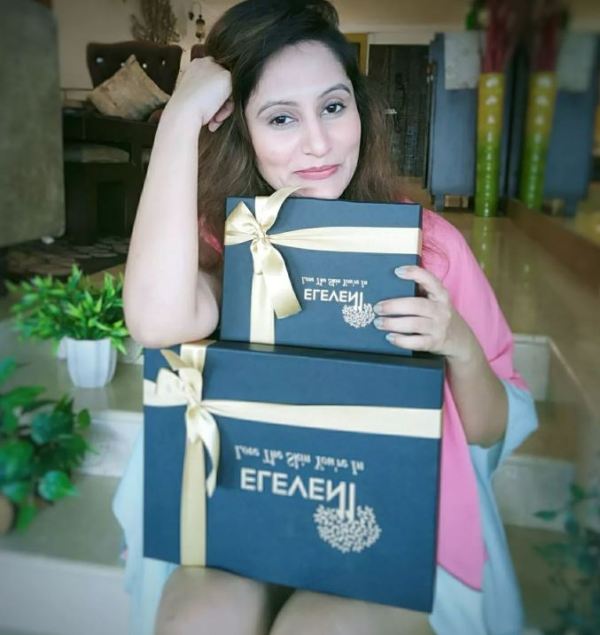 Aakshi Mathur holding Eleven11 luxe gift boxes