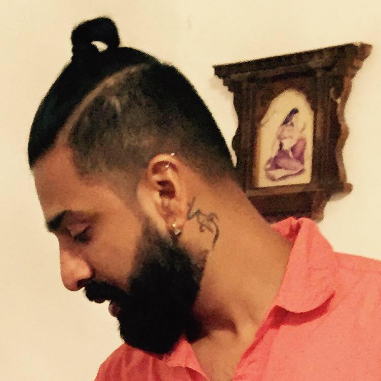 Abhishek's tattoo behind his ear and the piercings on his ear