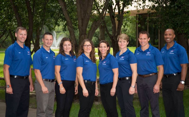 An image of Christina Hammock Koch (fourth from left), along with other 2013 astronaut class members, posing at NASA's Johnson Space Center in Houston on July 8, 2015, after receiving their astronaut pins, symbolizing the completion of their training