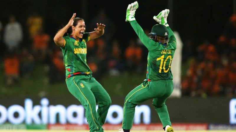 Chloé Tryon and Sinalo Jafta of South Africa celebrate getting the wicket of New Zealand cricketer Maddy Green during the 2023 ICC Women's T20 World Cup 