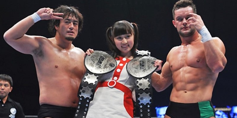 Finn with his Apollo 55 tag team partner after winning the tag team championship belt