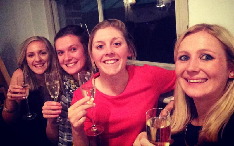 Heather Knight drinking champagne with her friends