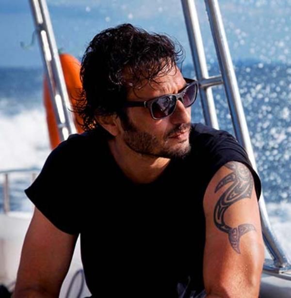 Homi Adajania tattoo on his right bicep