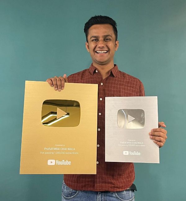 Prafull Billore while holding gold and silver YouTube Plaques