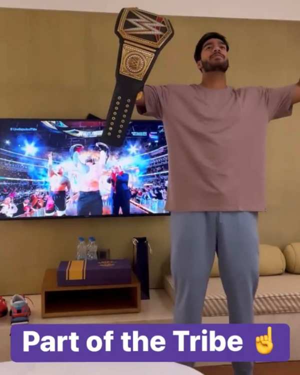 Venkatesh Iyer celebrating the win of Roman Reigns in a WWE match