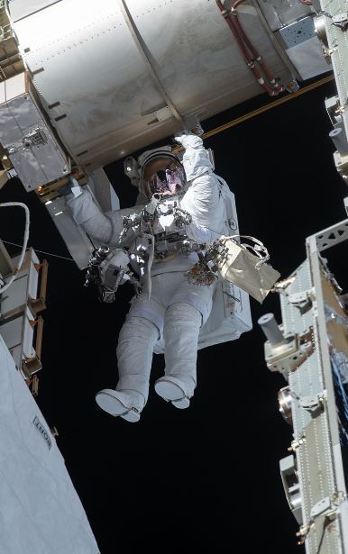 Victor J. Glover conducting his first space walk during expedition 64